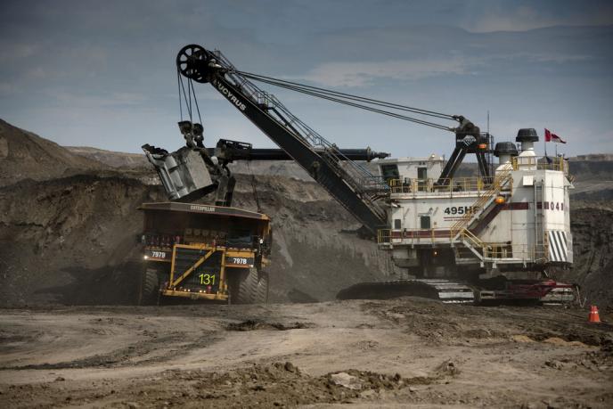 dump truck being loaded in the oil sands
