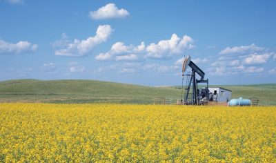 Alberta oil well in canola field