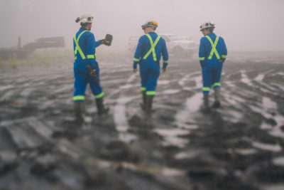 Workers walking in mud