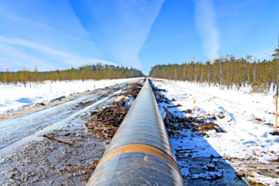 Working pipeline along the ground in winter.